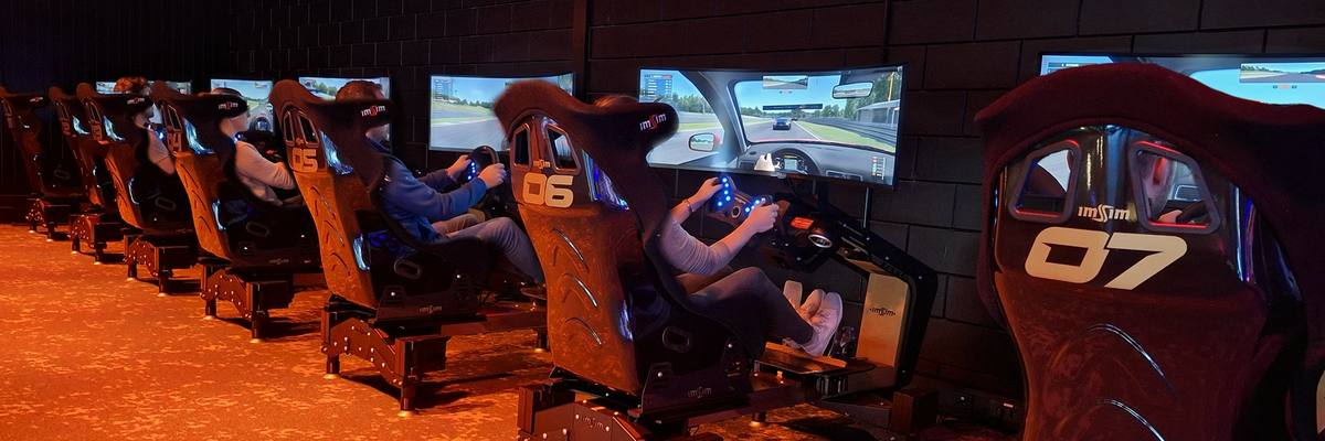 A hall of ImSim simulators with guests racing